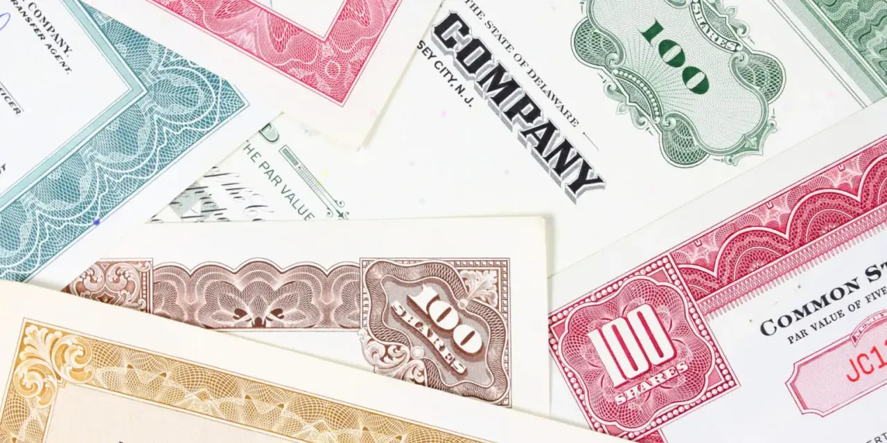 Różnorodne akcje total SA, z numerami 100 i innymi oznaczeniami, tworzą kolorowy kolaż.